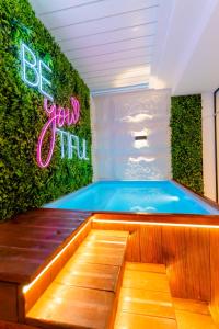 a swimming pool in a room with a green wall at Liveable artwork in Sousse