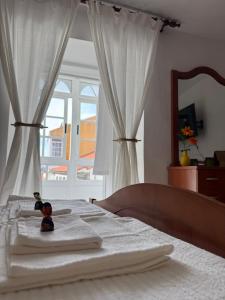 a teddy bear sitting on top of a bed at Casa do medio in Corcubión
