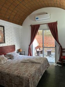 a bedroom with a bed and a window with a heater at Los Toneles Cafayate in Cafayate