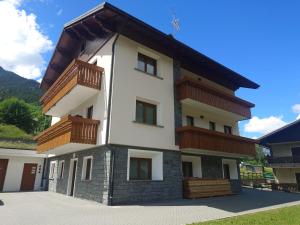a building with wooden balconies on top of it at Casa Marika in Valdisotto