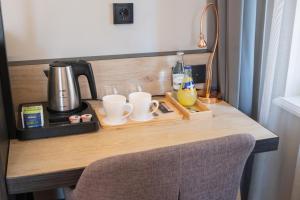 a table with a coffee maker and glasses on it at Hotel Villa Nord Hamburg-Airport in Hamburg +14 photos