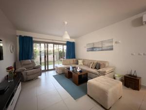a living room with a couch and a table at Condo in Marassi Marina in El Alamein
