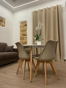 a dining room with a table and two chairs at Maiori Vacation Home in Cinisi