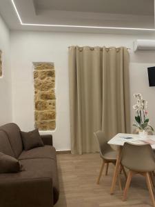 a living room with a couch and a table at Maiori Vacation Home in Cinisi