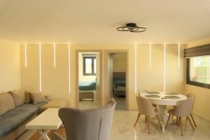 a living room with a couch and a table at Calliroe Sea View in Alexandroupoli