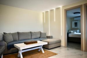 a living room with a couch and a coffee table at Calliroe Sea View in Alexandroupoli
