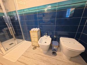 a bathroom with a toilet and a shower at La casa di venera in Bacoli +12 photos
