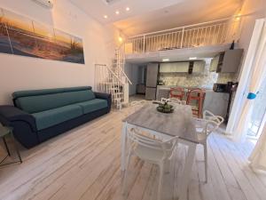 a living room with a blue couch and a table at La casa di venera in Bacoli