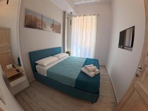 a bedroom with a bed with two towels on it at La casa di venera in Bacoli