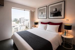 a bedroom with a large bed and a large window at BTH Hotel – Boutique Concept in Lima +89 photos