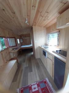 an interior view of a kitchen in a tiny house at La Roulotte de piégut in Piégut-Pluviers