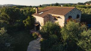 an aerial view of a stone house with trees at Kidóni Villas in Gaïtánion