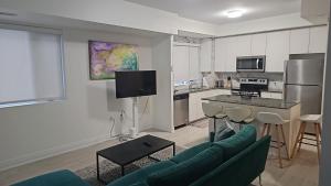 a living room with a couch and a kitchen at GGP Boutique Townhome in Vaughan