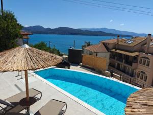 a swimming pool with a view of the water at Episkopos Escape in Nikiana