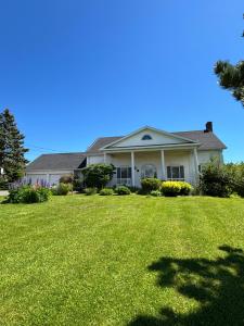 a house with a large lawn in front of it at Seaview White House in Stratford