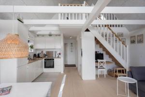 a kitchen and living room with white cabinets and a staircase at M411-Gedser-Sdr-Boulevard-6-B in Gedser