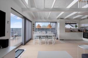 a kitchen and dining room with a table and chairs at M411-Gedser-Sdr-Boulevard-6-B in Gedser +14 photos