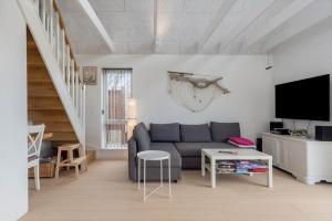 a living room with a couch and a tv at M411-Gedser-Sdr-Boulevard-6-B in Gedser