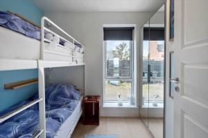 a small bedroom with bunk beds and a window at M411-Gedser-Sdr-Boulevard-6-B in Gedser