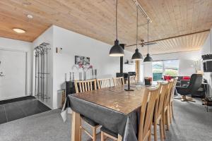 a dining room and living room with a table and chairs at C11241-Hemmet-Ildervej-22 in Hemmet