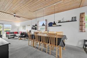 a dining room and living room with a table and chairs at C11241-Hemmet-Ildervej-22 in Hemmet +18 photos