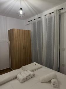 a bathroom with towels on a bed in front of a mirror at Xenia's Resorts in Ofrínion