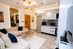 a living room with a couch and a table at Liveable artwork in Sousse