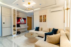 a living room with a couch and a table at Liveable artwork in Sousse
