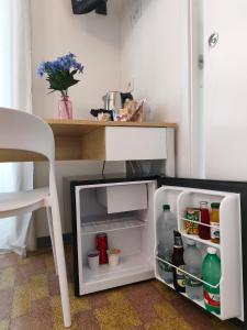 an open refrigerator with food and drinks in it at Palazzo San Giorgio 1924 in Scilla