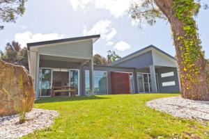 a modern house with a green yard at Waterfront Apartments in Devonport