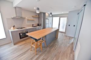 uma cozinha com uma mesa de madeira e um piso de madeira em Waterfront Apartments em Devonport