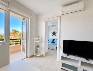 a living room with a large flat screen tv at Casa Sol de Jandía in Morro del Jable