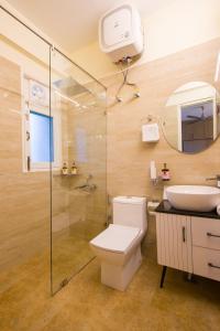 a bathroom with a toilet and a sink and a shower at The Walnut Stays in Solan +57 photos