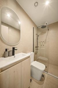 a bathroom with a sink and a toilet and a mirror at Ormos Piraeus in Piraeus +43 photos