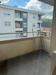 a balcony with a metal hand railing and a building at Golden Lux in Berane +1 photo