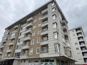 a tall building with windows on the side of it at Golden Lux in Berane