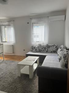 a living room with a couch and a coffee table at Golden Lux in Berane