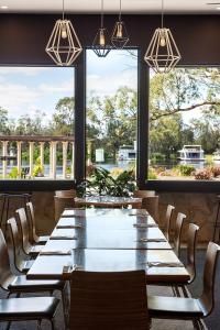 a large dining room with a large table and windows at Berri Hotel in Berri
