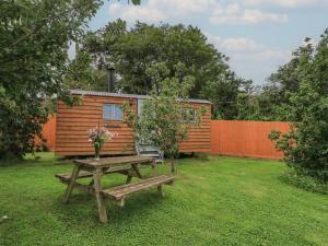 a picnic table and a house in a yard at Bramleys in Taunton
