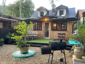 a house with a patio with a table and chairs at Dove Cottage Chatka 35 Chalmová in Bystričany