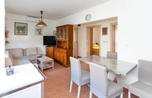 a kitchen and living room with a table and chairs at Apartmants 38 in Pag