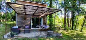 a tiny house with a pergola at Kilomètre creusois in Saint-Dizier-Leyrenne