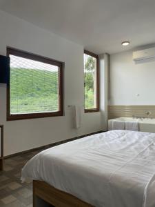 a bedroom with a large bed and a sink at Gorna Kukja Apartments in Demir Hisar