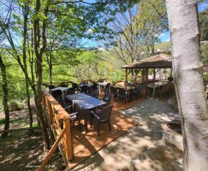 a patio with tables and chairs and a gazebo at Gorna Kukja Apartments in Demir Hisar