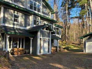 a large house with a garage in front of it at CrossLake Getaway in Cross Lake