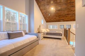 a bedroom with two beds and two windows at CrossLake Getaway in Cross Lake