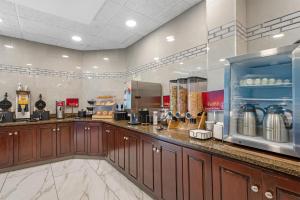 a kitchen with wooden cabinets and a counter at Best Western Plus Indianapolis in Indianapolis