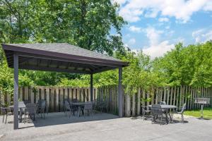 a pavilion with tables and chairs and a fence at Best Western Plus Indianapolis in Indianapolis