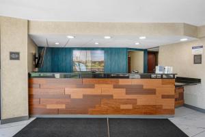 an office lobby with a reception desk with wood at Best Western Plus Indianapolis in Indianapolis +58 photos
