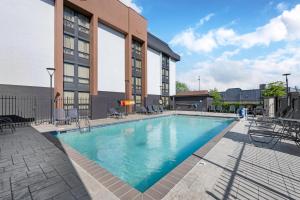 a large swimming pool in front of a building at Best Western Plus Indianapolis in Indianapolis